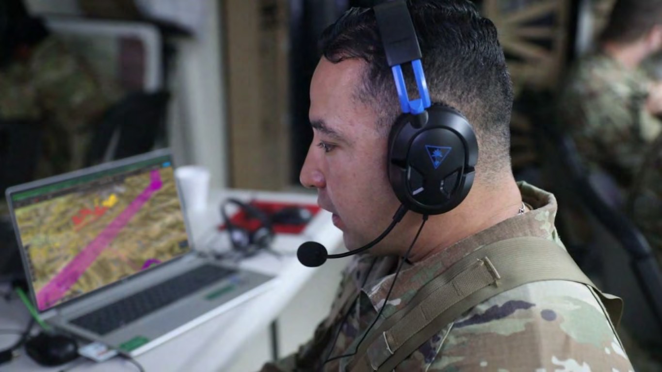 Planner wearing a headset building a flight route in Eris on a laptop